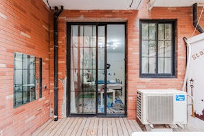A room with a sliding glass door, a window, and an air conditioning unit. - Qiyu Homestay - West Nanjing Road Branch (Shanghai)