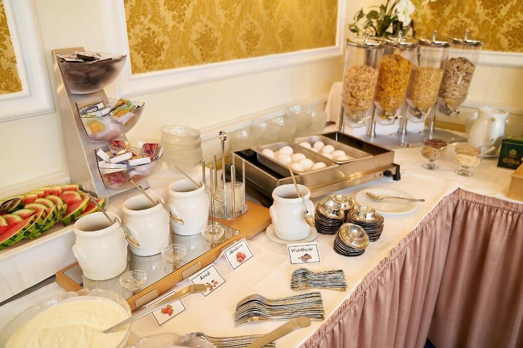 A buffet setup with various food items and utensils.