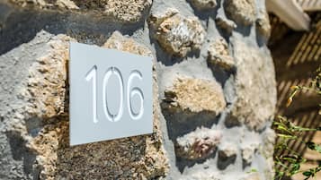 Un muro de piedra con un letrero que muestra el número 106.