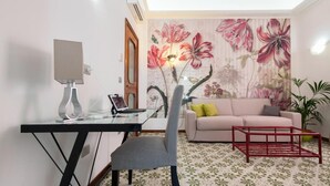 A modern living room with a desk, a sofa, and a red coffee table. - B&B Antonello (Salerno)