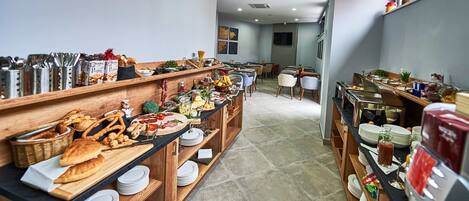 A buffet setup with various food items and utensils on wooden shelves and tables.