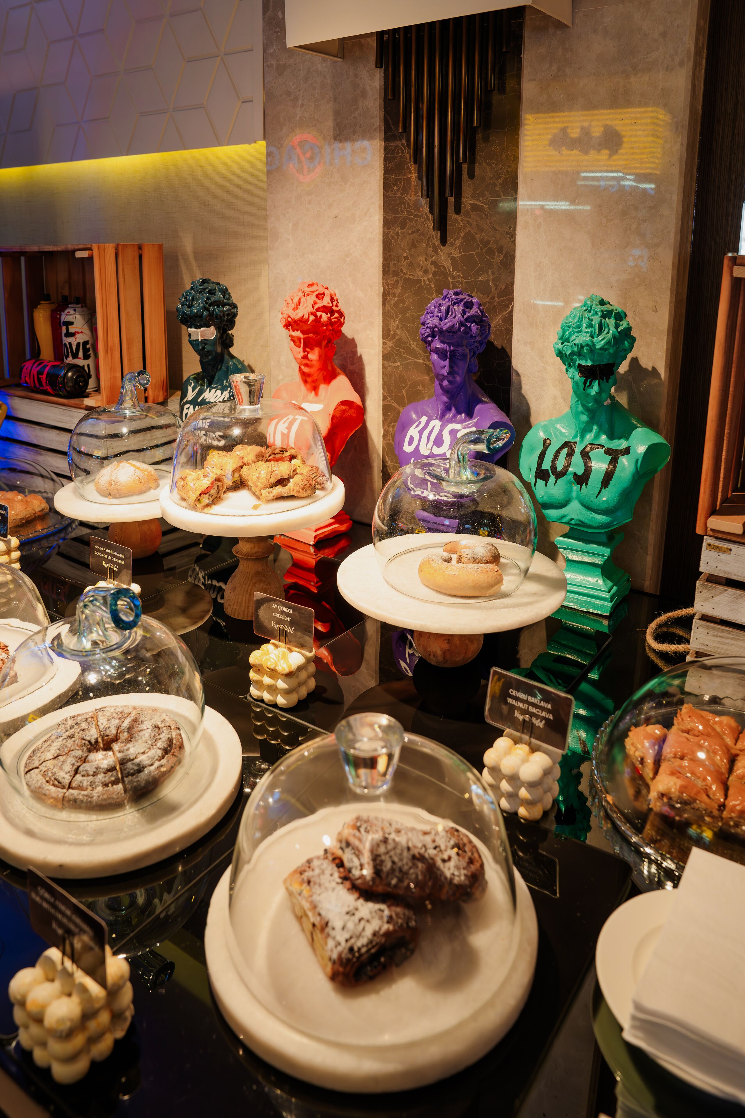 A dessert display with various pastries and a sign indicating a 'Lost' theme.