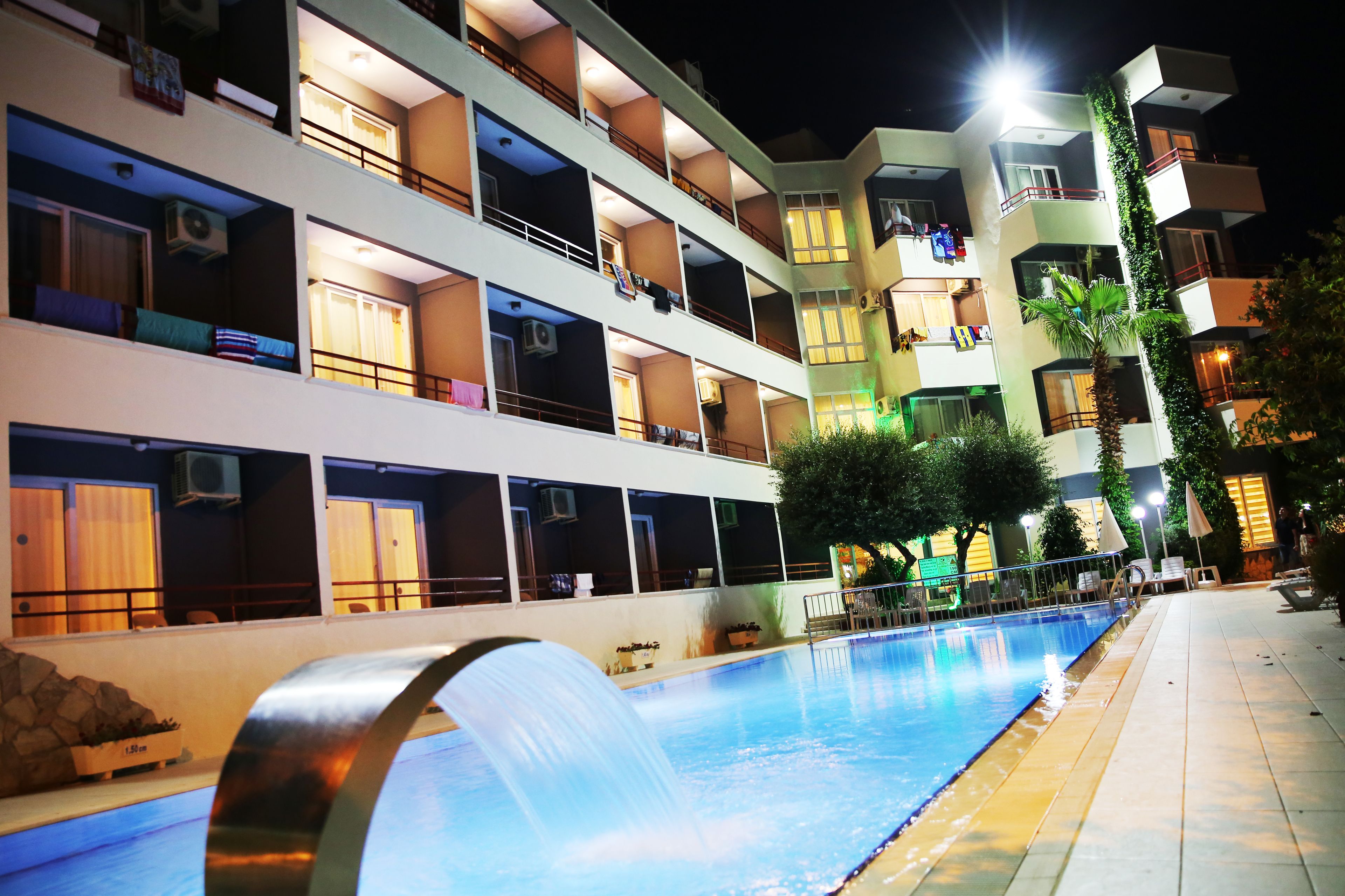 Outdoor pool, a waterfall pool, pool umbrellas, pool loungers