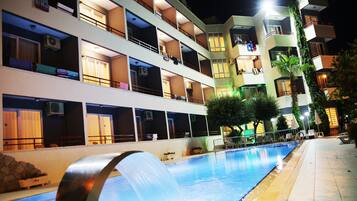 Outdoor pool, a waterfall pool, pool umbrellas, pool loungers