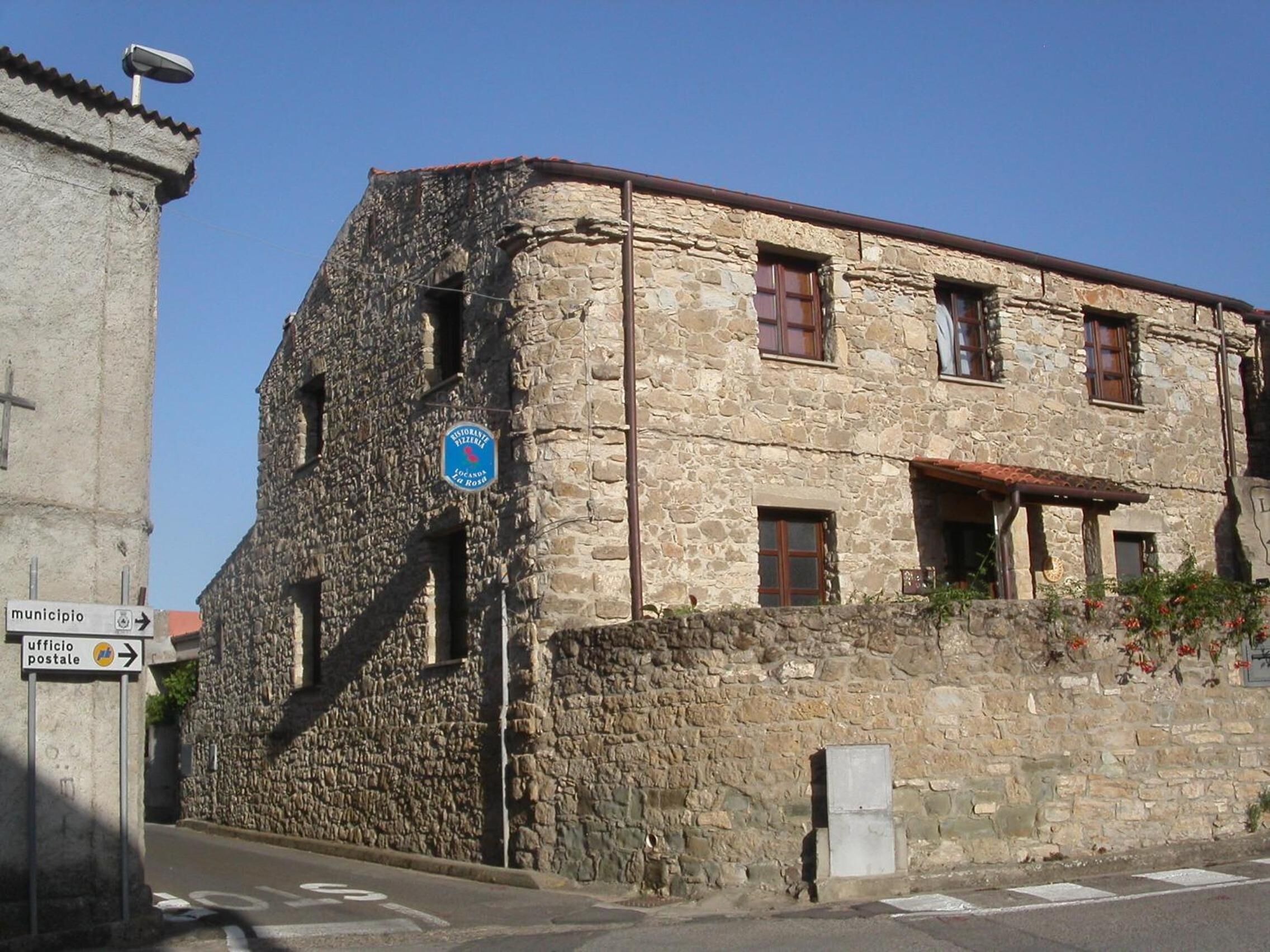A stone building with a sign indicating a restaurant.