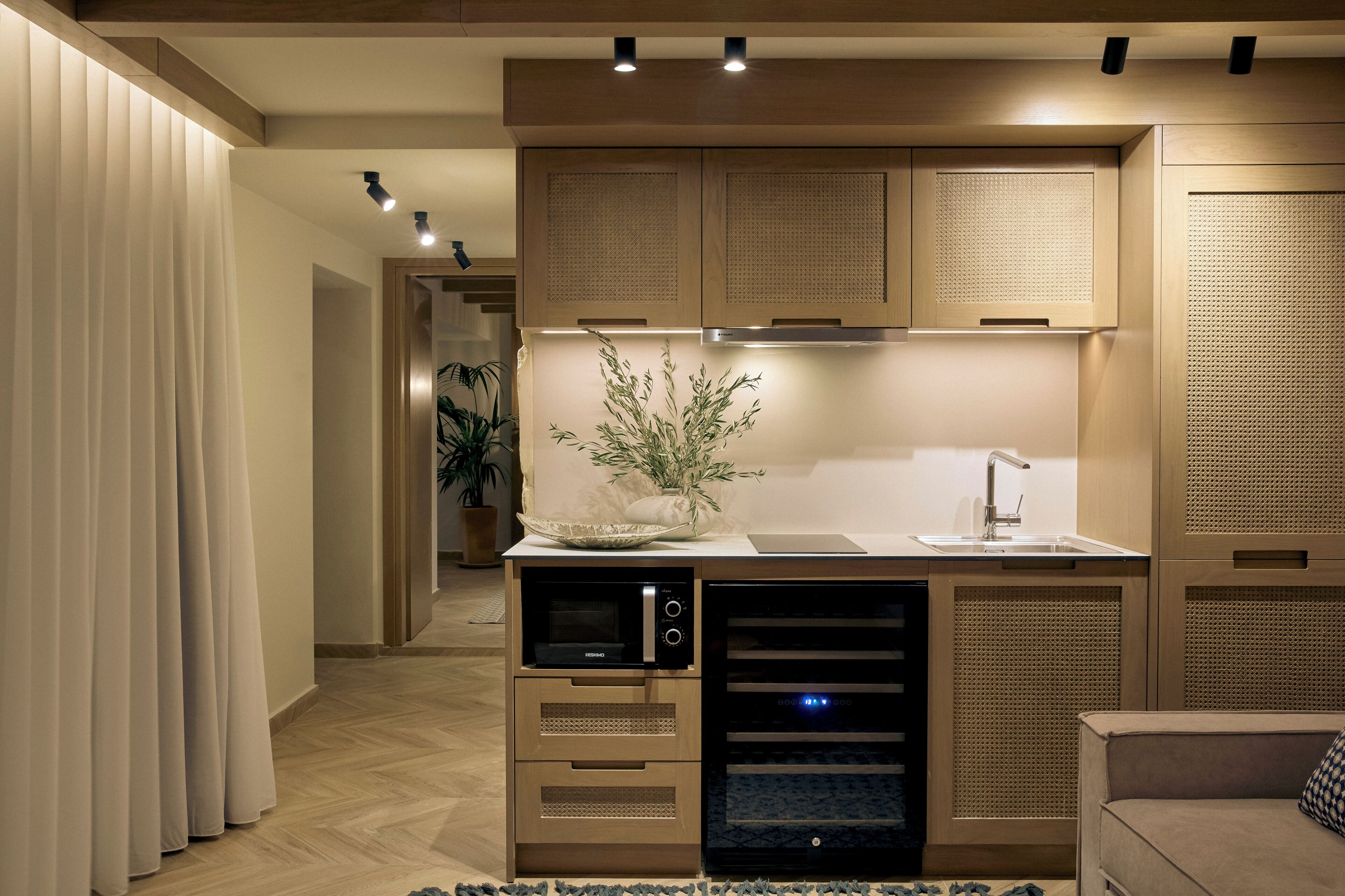 A modern kitchen with built-in appliances, a central island, and a dining area.
