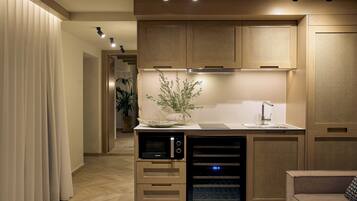 A modern kitchen with built-in appliances, a central island, and a dining area.
