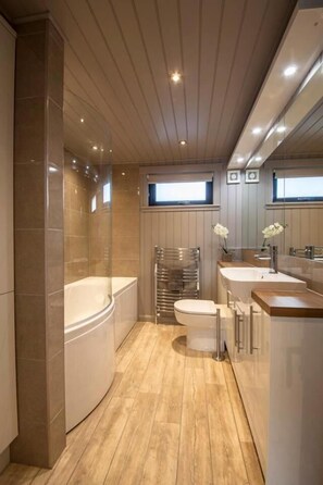 Separate bathtub and shower, towels