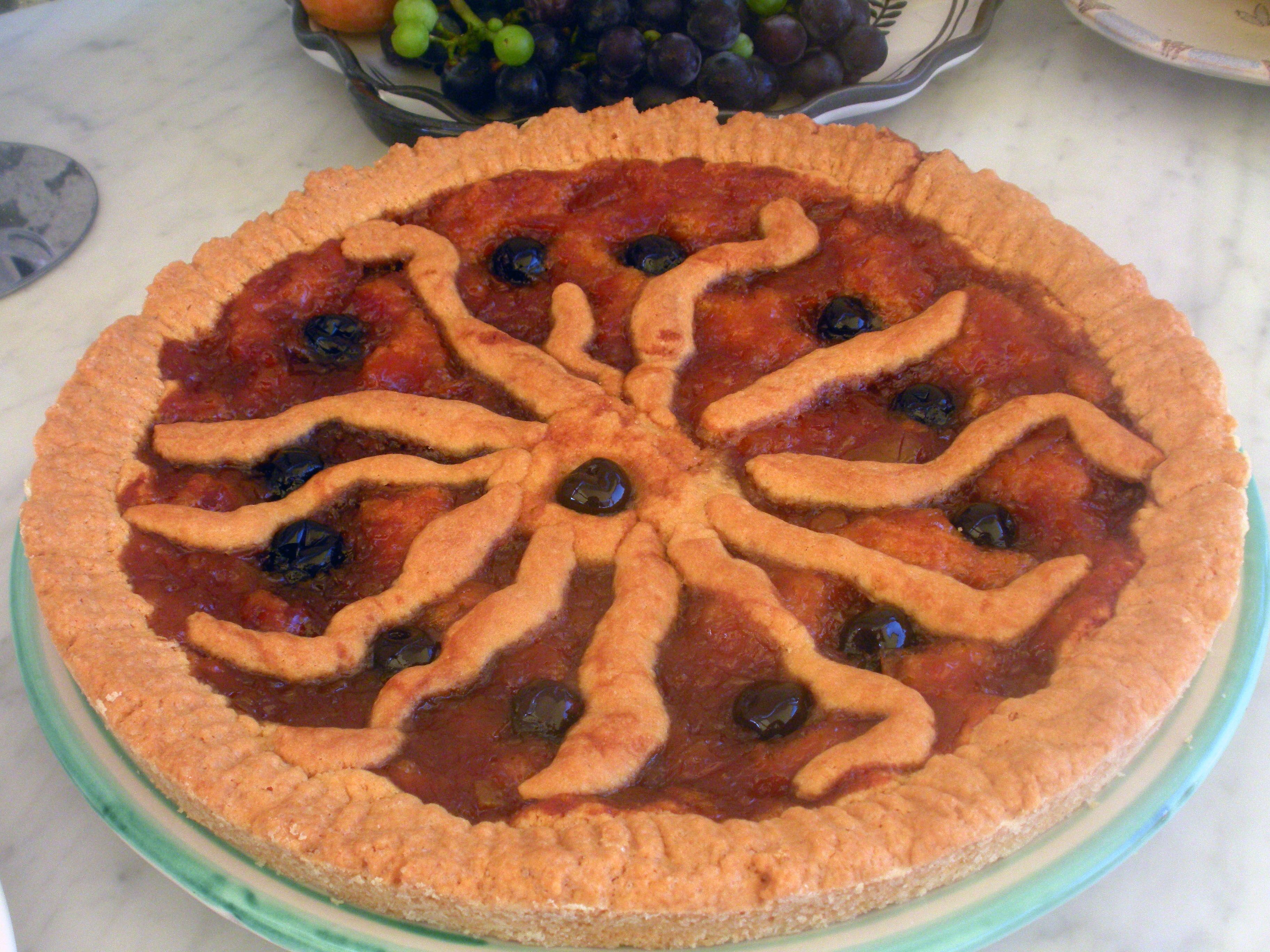 A pie with a decorative lattice crust on a glass plate.