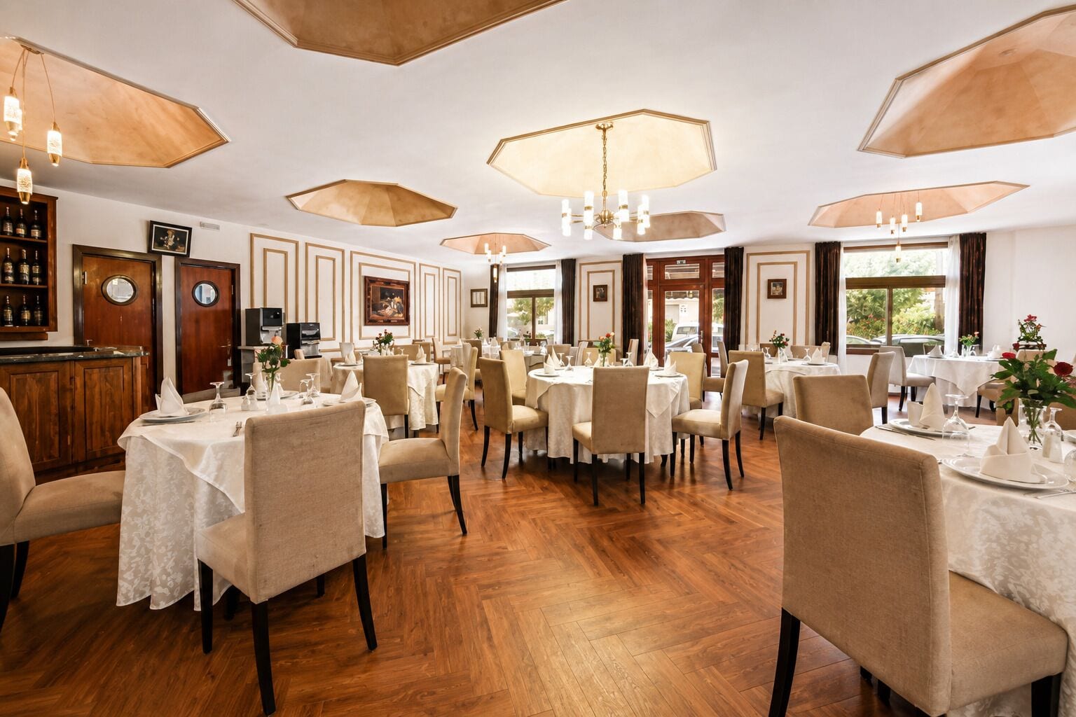 Ein Restaurant mit mehreren Tischen, Stühlen und einer Bar.