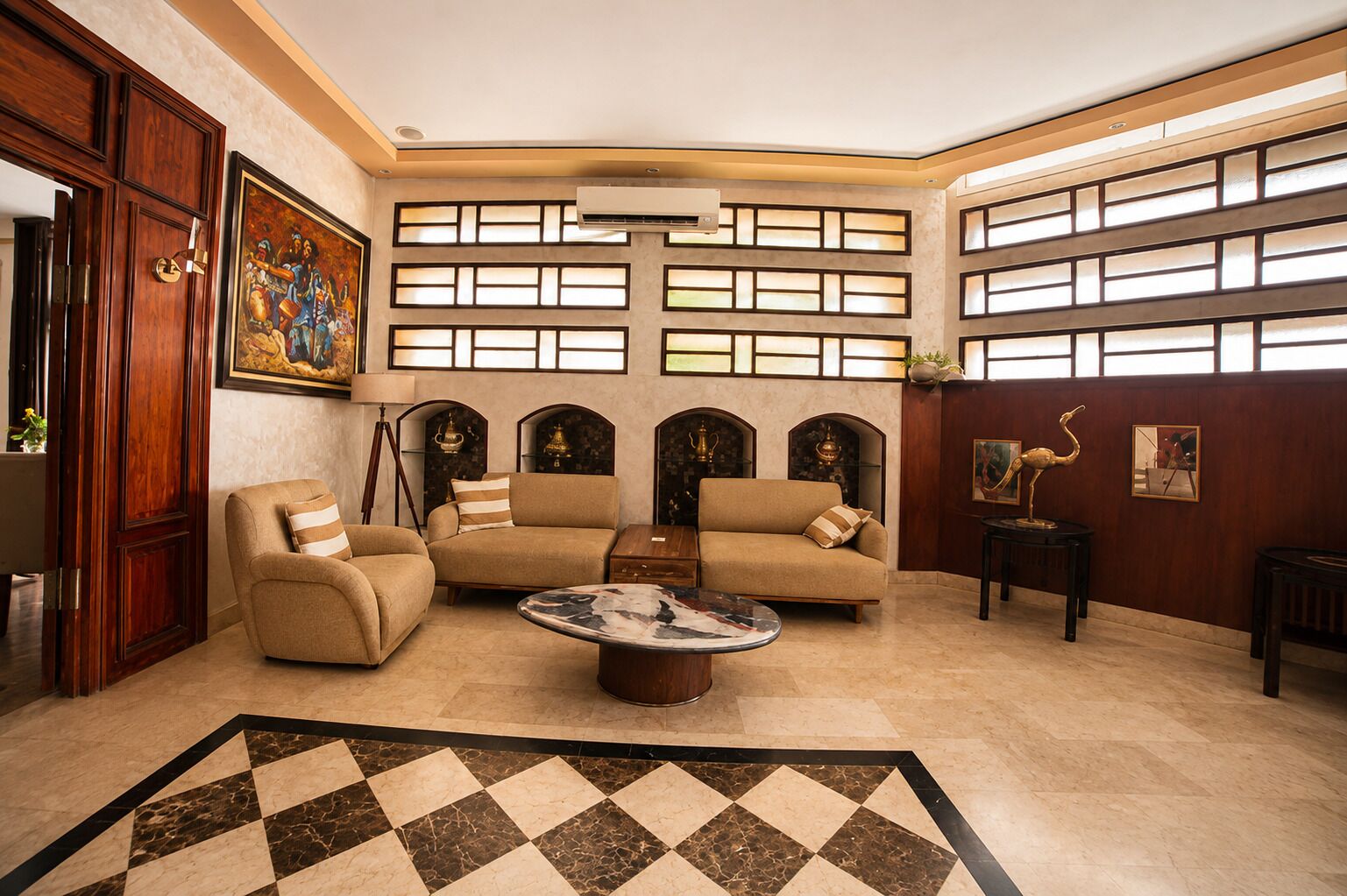 A spacious living room with a large sofa set, a coffee table, and a patterned rug.