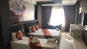 A hotel room with two beds, a desk, a chair, a TV, and a painting of a building on the wall. - Ozcelik Hotel (Salihli)