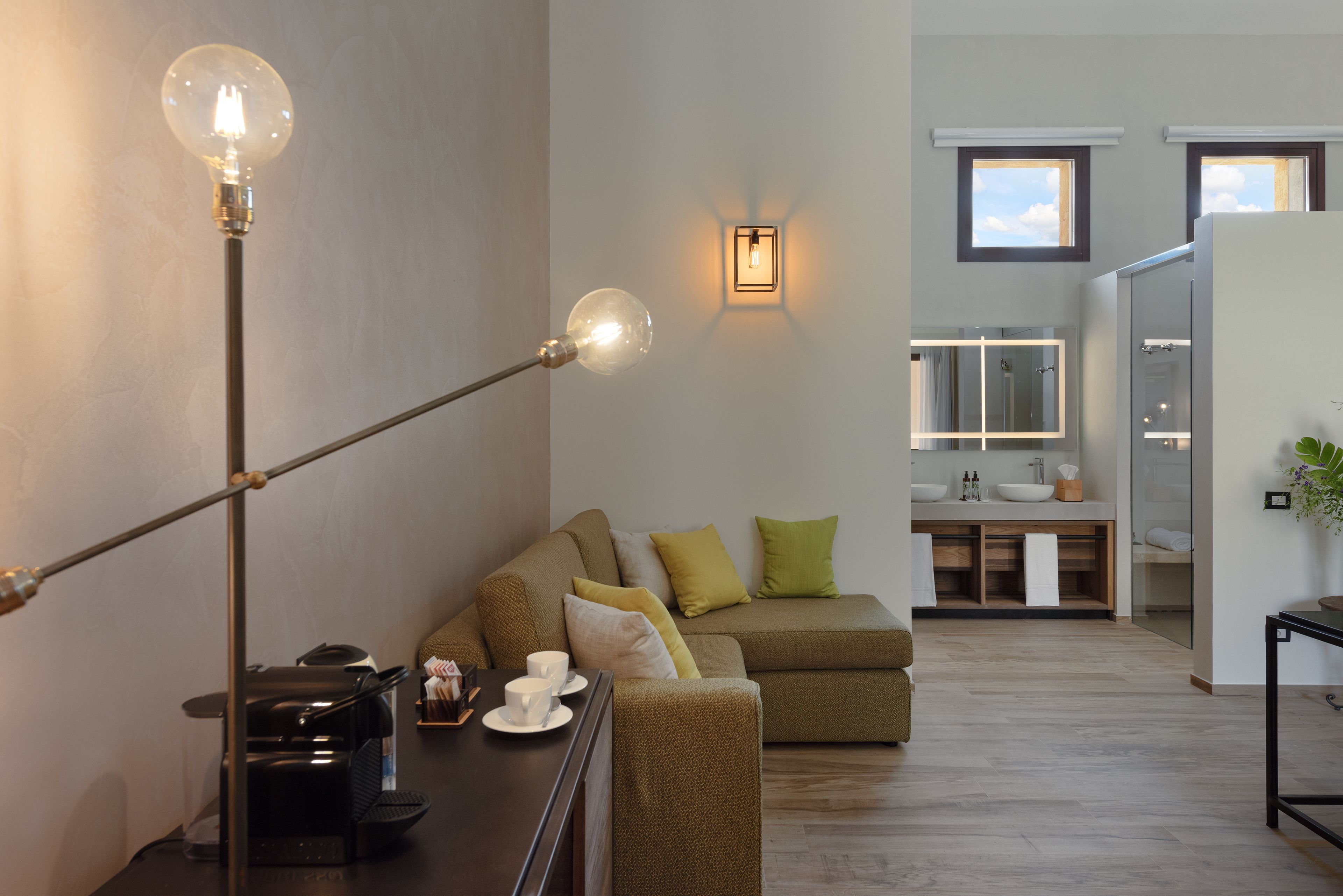 A modern living room with a sofa, a coffee table, and a floor lamp.
