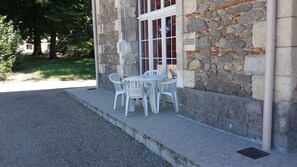 Guests can enjoy an outdoor seating area with a table and four chairs.