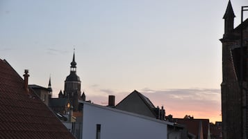 A cityscape with a prominent church tower and adjacent buildings.