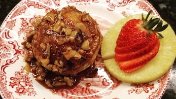A plate with a dessert and a strawberry.