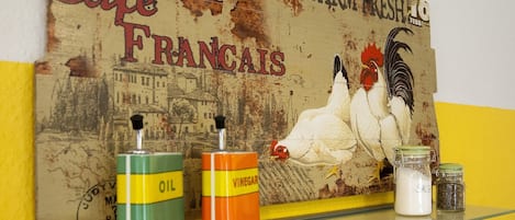 A wall with a vintage poster featuring chickens and the text "Healthy Cafe Francais Farm Fresh."