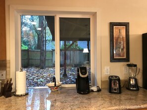 Enjoy cooking in this well-equipped kitchen with a coffee maker, toaster, and blender, and take in the view of the backyard through the window.
