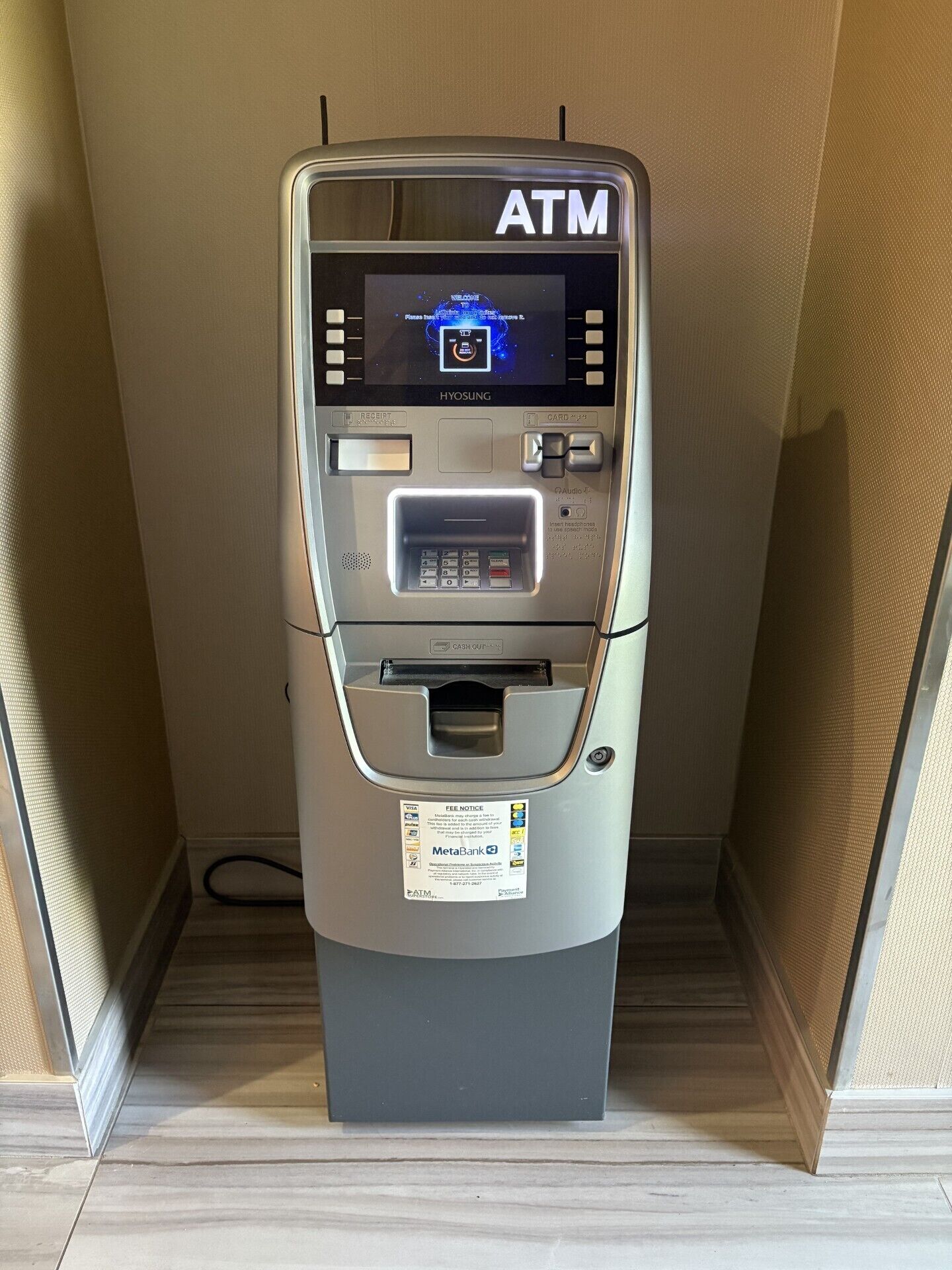 An ATM machine with a receipt slot, card reader, and cash dispenser.