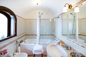 Ein Badezimmer mit Badewanne, Waschbecken, Toilette und Dusche.