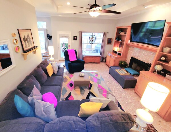 Smart-tv, een open haard, boeken en een kantoor