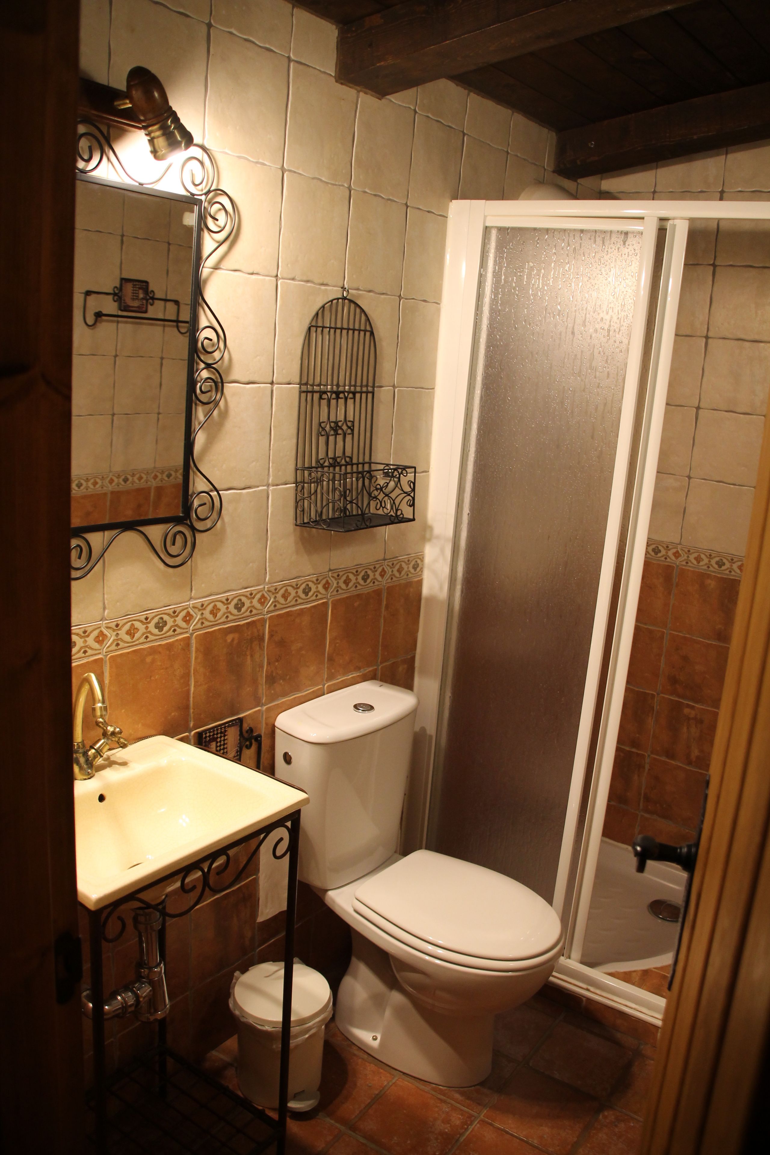 A bathroom with a sink, toilet, and shower.