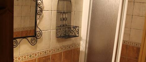 A bathroom with a sink, toilet, and shower.