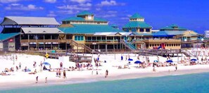 A beachfront hotel with multiple buildings, a sandy beach, and a pier. - EASY ACCESS! Step off your Patio & into the Pool / Steps to Beach / Ocean View! (Fort Walton Beach)