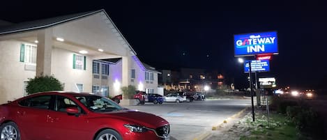 A GATEWAY INN building with a red car parked in front.