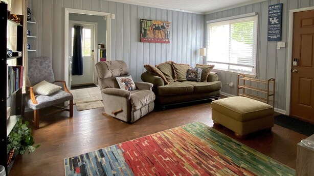 A living room with a sofa, armchairs, a coffee table, and a colorful rug. - SPACIOUS country home, Sleeps 6 adults  (Nicholasville)