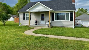 A single-story house with a front porch, a chimney, and a number 230 on the front. - SPACIOUS country home, Sleeps 6 adults  (Nicholasville)