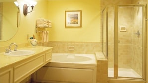 A bathroom with a large sink, a bathtub, and a walk-in shower. - Turtle Cay - Key-West Style 2Bedrm 2.5bath Full Week Oceanview July 10-17 (Virginia Beach)