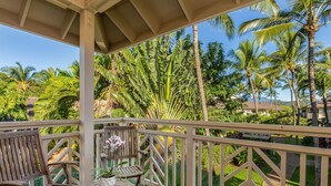 A wooden deck with a railing, a table, and two chairs. - 3BR/3BA Villa: Central A/C! Short Walk To Beach! (Koloa)