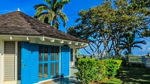 A house with a blue door and a white exterior. - Villa Island Breeze (Duncans)