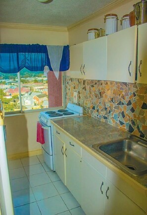 Apartment | Private kitchen | Fridge, stovetop, cookware/dishes/utensils - Sky Blue Beach Studio at Turtle Towers (Ocho Rios)