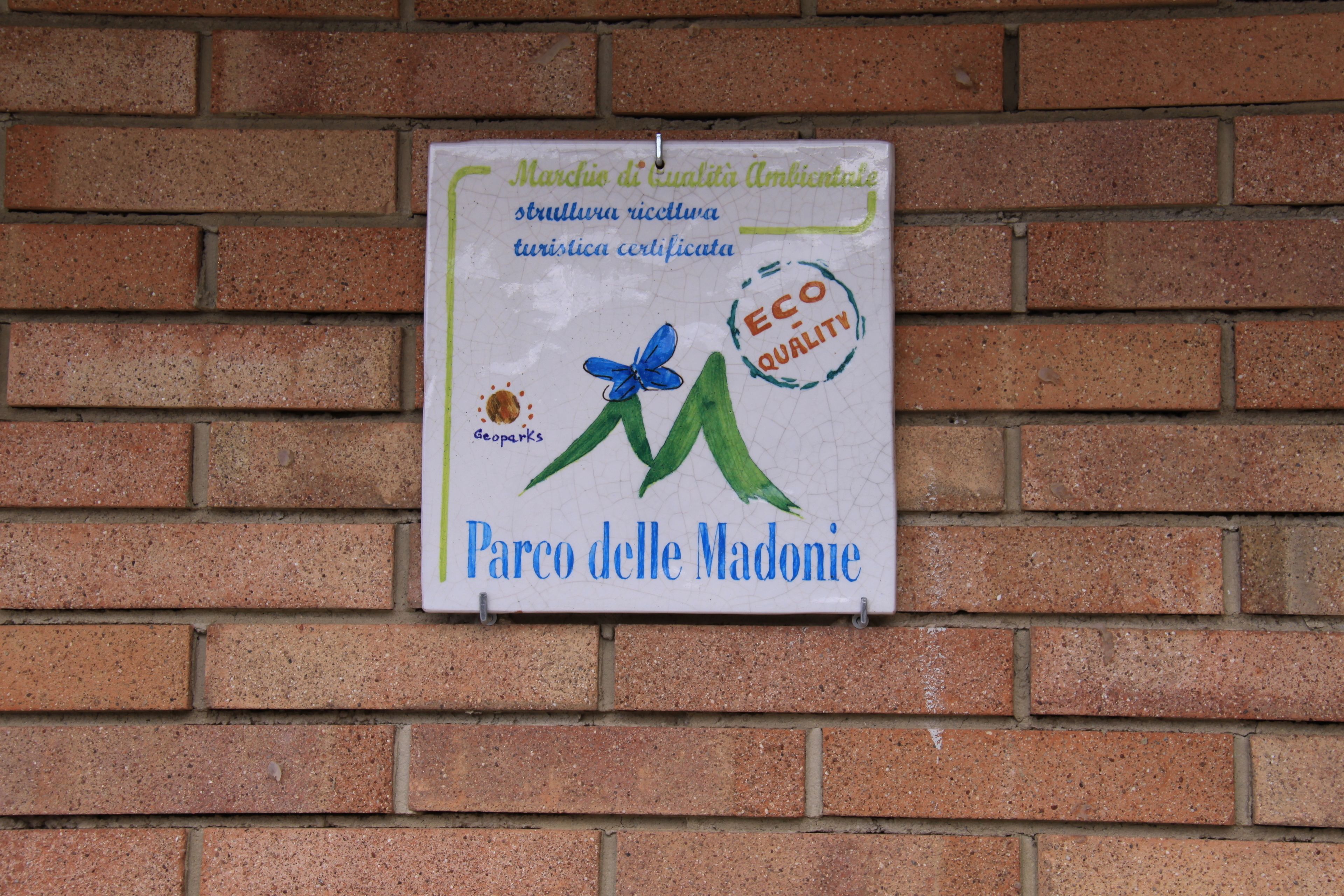 A sign on a brick wall.