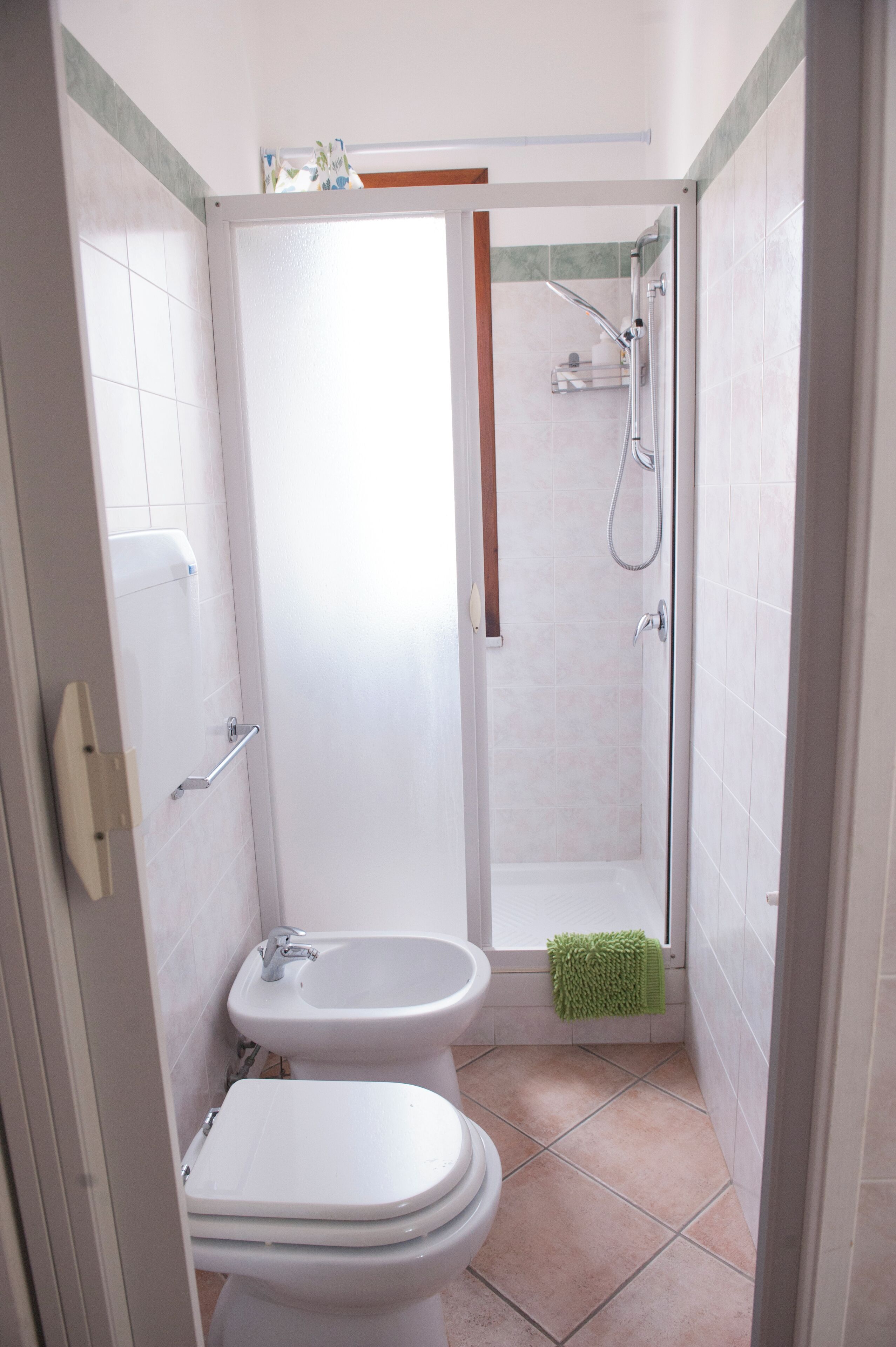 Une salle de bain équipée de toilettes, d’un bidet et d’une douche.