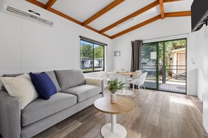 Deluxe Cabin (2BR) - Sleeps 6 | Living area | Flat-screen TV, DVD player