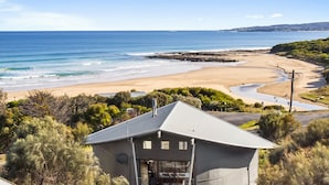 A coastal house with a view of the beach and ocean.