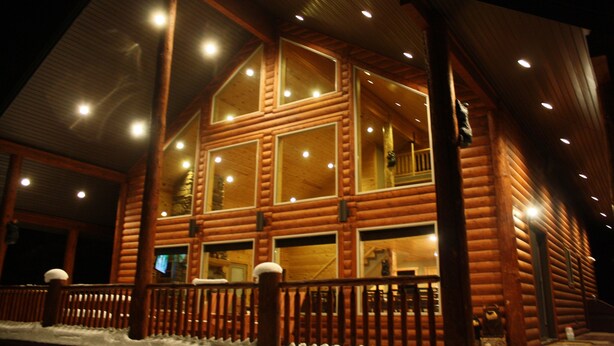 A log cabin with multiple windows and a balcony. - Beautiful Cabin In The Trees w/Jacuzzi & Pool Table - 20 Mins From Yellowstone (Island Park)