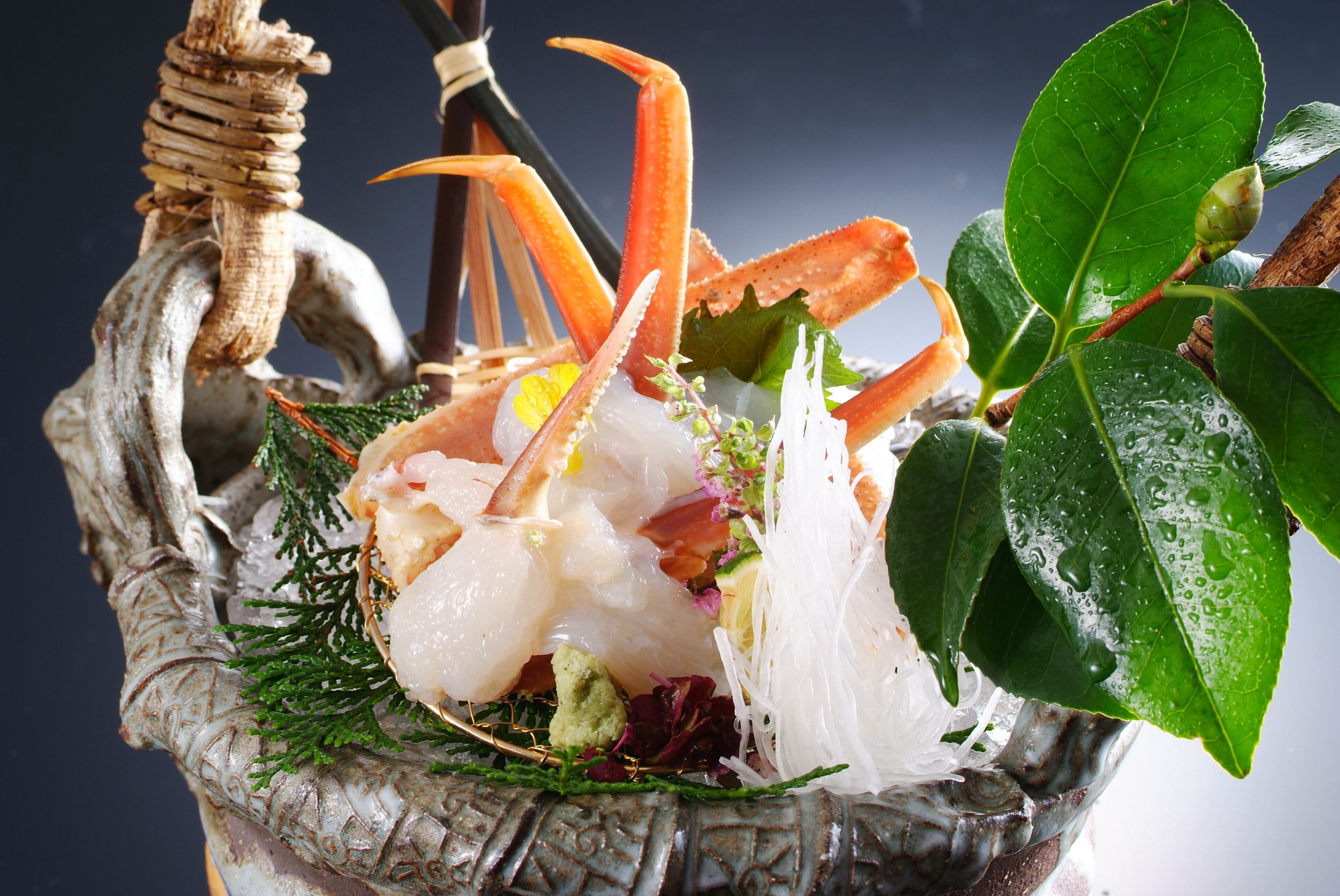 A seafood dish in a decorative bowl with a handle.