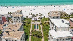 A high-rise hotel with a rooftop pool, a tennis court, and a beach view. - Island House Beach Resort 14N (Siesta Key)