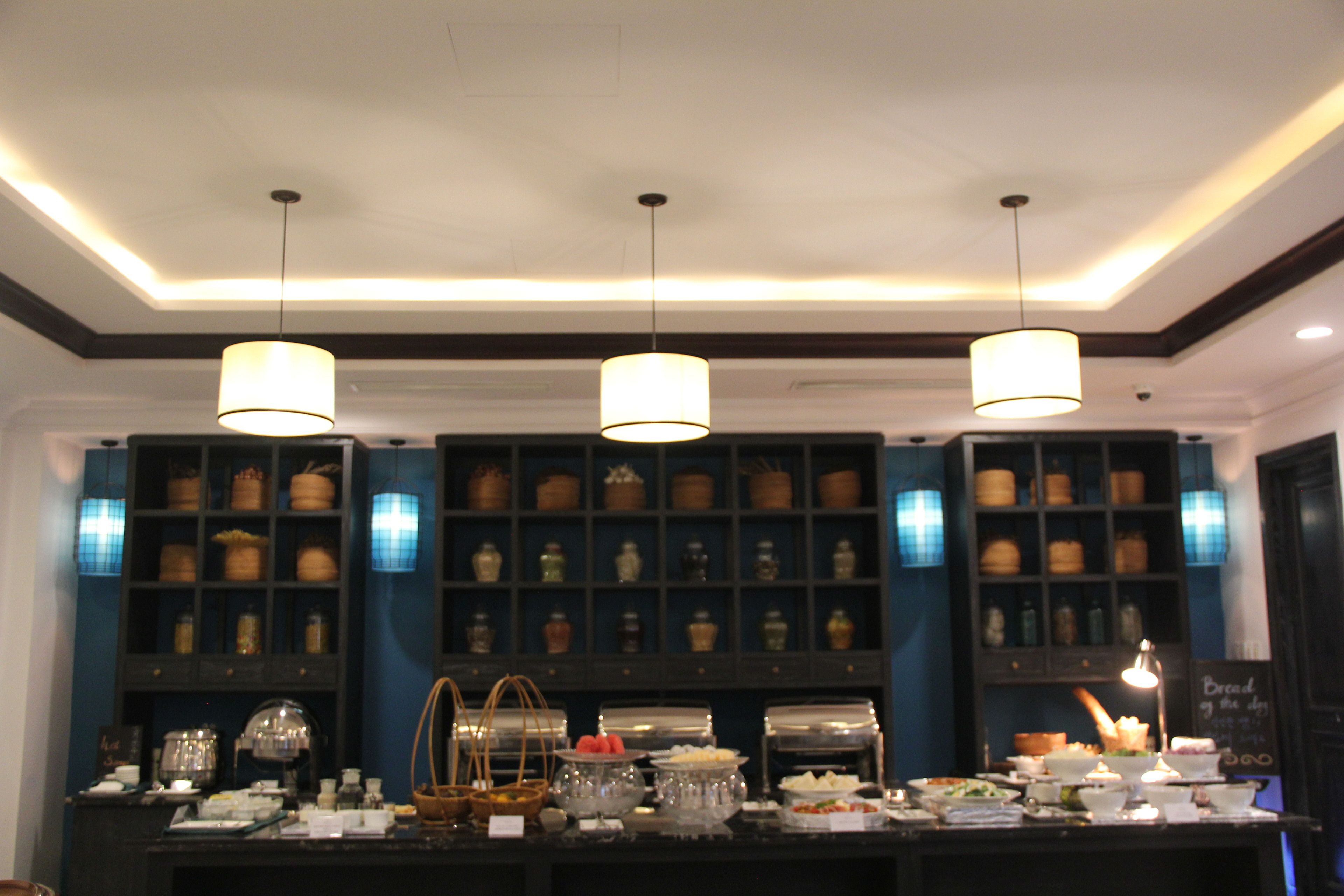 A buffet area with a variety of food items and a selection of jars and containers on shelves.