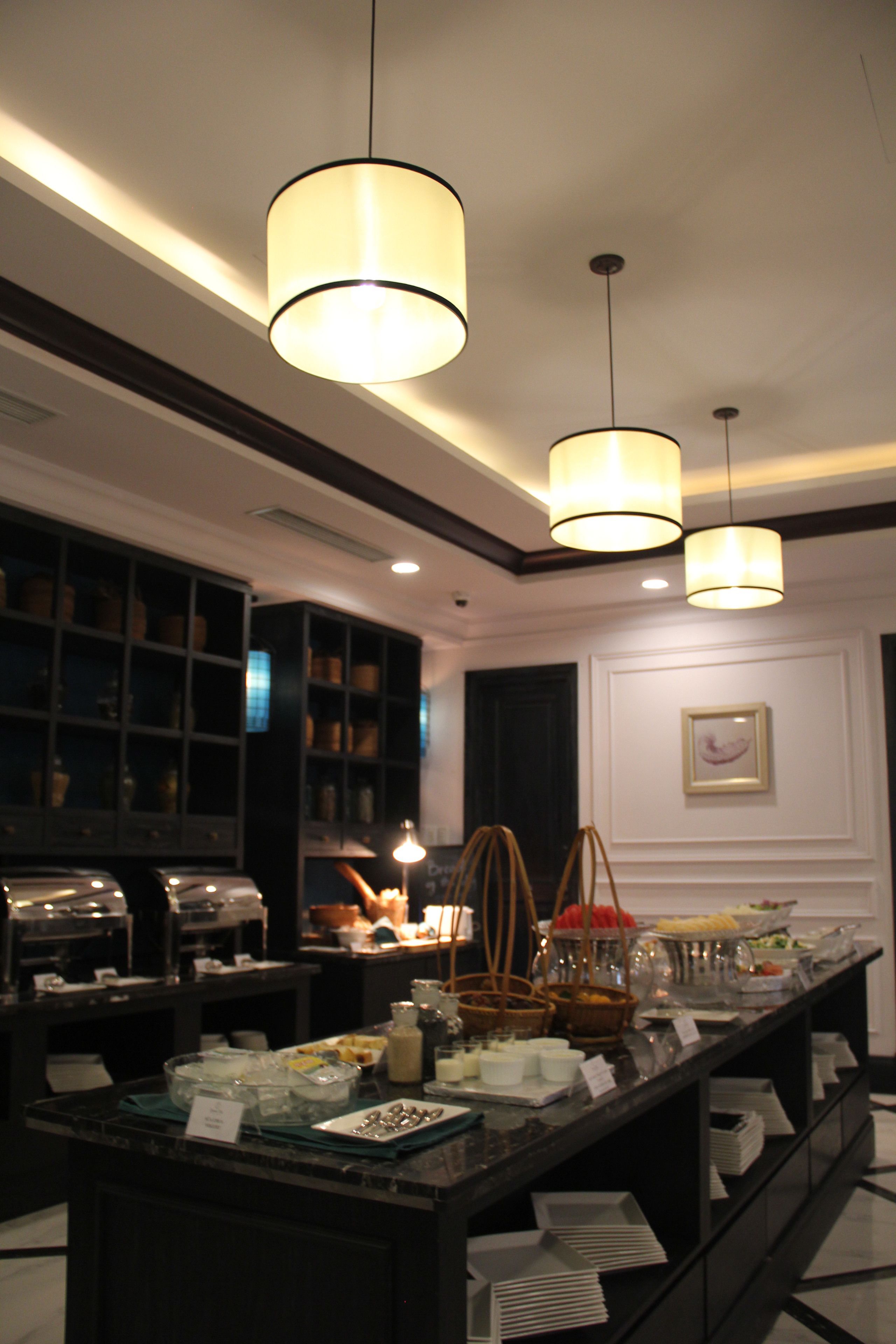 A buffet setup with a variety of food items and a coffee station.