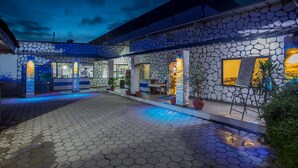 A stone building with a bar named "HUNGA BAR" and a seating area with potted plants. - Siddhartha Cottage Butwal (Butwal)