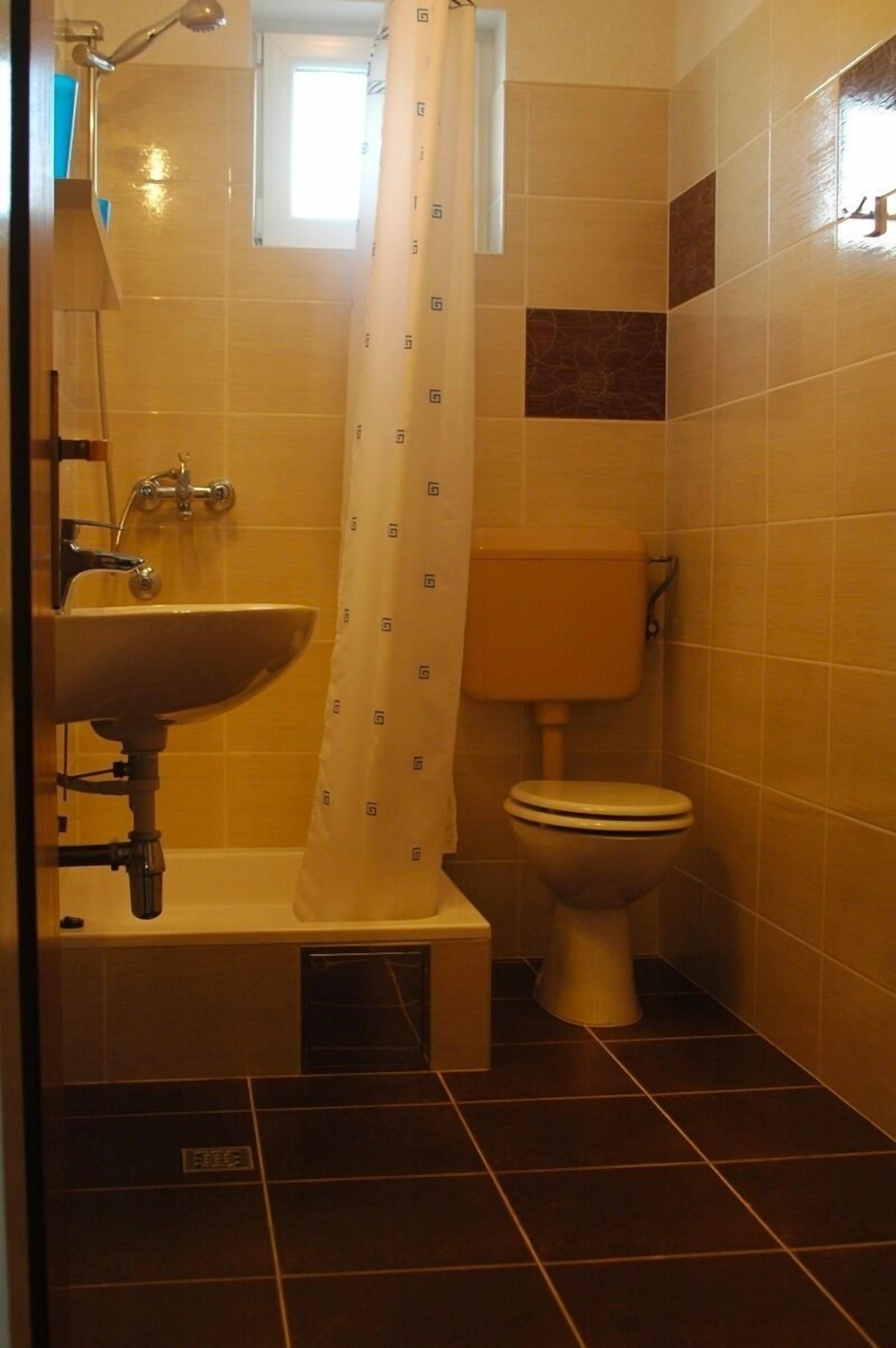 A bathroom with a sink, toilet, and shower.