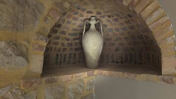 A stone oven with a large vase placed inside.