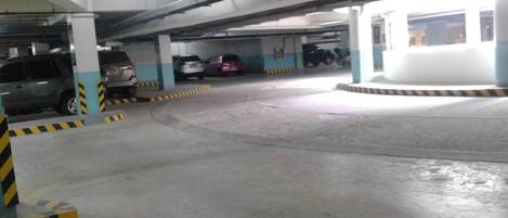 A multi-level parking garage with several cars parked.