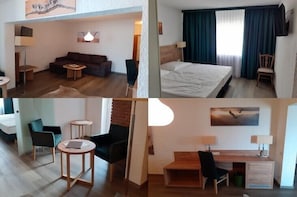 A hotel room with a bed, a desk, a chair, a sofa, and a small table. - Land Gut Hotel Zum Alten Forsthaus (Huertgenwald)