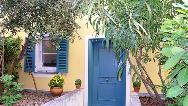 A blue door with a potted plant beside it, a window with blue shutters, and a small tree in the foreground. - COLLINE DU CHATEAU AP4077 by RIVIERA HOLIDAY HOMES (Niza)